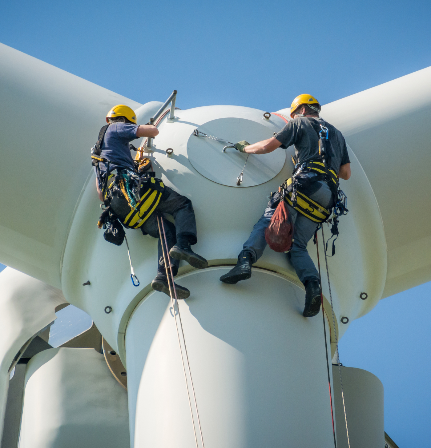 Two possible contract workers, fixing an issue on a windfarm